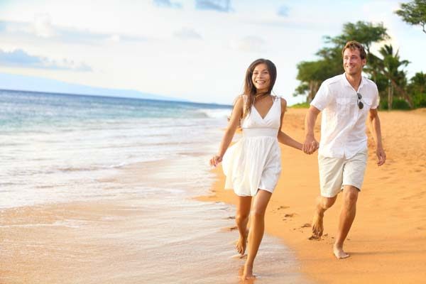 couple walking on beach after immigration gurus help with partner visa australia